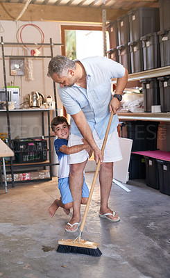 Buy stock photo Home, family and kid cleaning or sweep, garage and broom for dust or dirt remove. Happy, playful son with father for housework maintenance and bonding, chores with clearing out and equipment