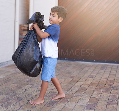 Buy stock photo Shot of a little boy taking out the trash at home