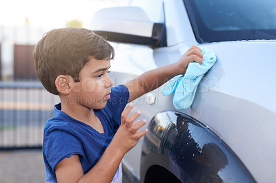 Buy stock photo Child, car wash and cleaning or outdoor chore as youth learning for to do list, responsibility or discipline. Boy, cloth and vehicle outside for daily task or household helping, independence or duty