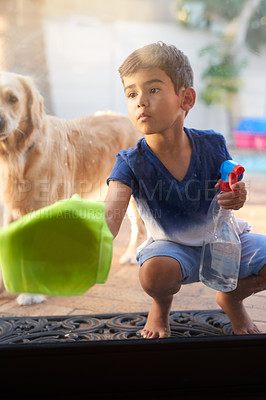 Buy stock photo Spray bottle, cloth and child cleaning window to prevent dirt, germs or bacteria with dog at home. Detergent, hygiene and boy kid wipe glass door for sanitizing with pet puppy in backyard at house.