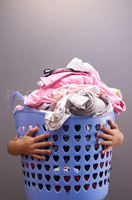 Buy stock photo Laundry, child and basket in family home for development, cleaning and helping in apartment. Hands, kid and cleaning service for clothes and linen in house for learning, support and household chores.