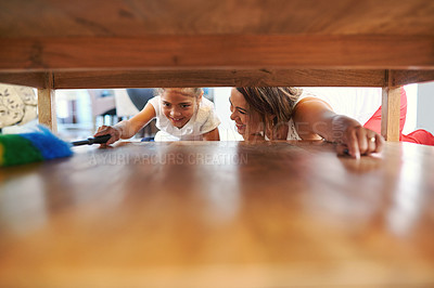 Buy stock photo Shot of a mother and daughter cleaning around the house