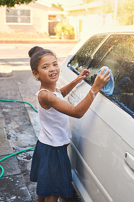 Buy stock photo Portrait, young girl and car in driveway with water for cleaning, soap and cloth outdoors at home. Happy kid, washing and vehicle at house for helping, transport and lesson for responsibility.