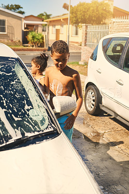 Buy stock photo Boy, carwash and vehicle in home, soap and driveway with help of family. Child siblings, bonding or duty for cleaning with sister and responsibility on weekend for household task with auto foam wash 