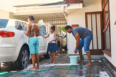 Buy stock photo Shot of a family washing a car together outside