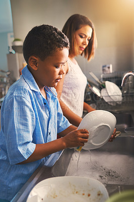 Buy stock photo Mother, son and dishes in kitchen with help or teamwork, tasks with collaboration in home. Woman, boy and cleaning plate in house with water and soap, working together or cooperation with happiness