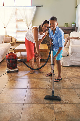 Buy stock photo Portrait of a mother and son vacuuming the floor