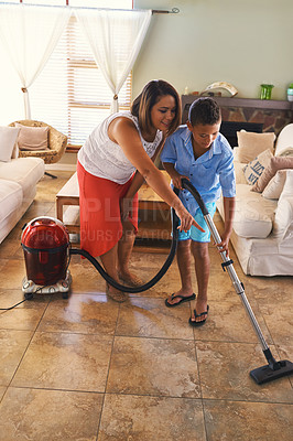 Buy stock photo Mother, child and cleaning by vacuum floor of living room as teamwork to learning responsibility at home. Father, children and working together by helping, bonding and cooperation for natural growth
