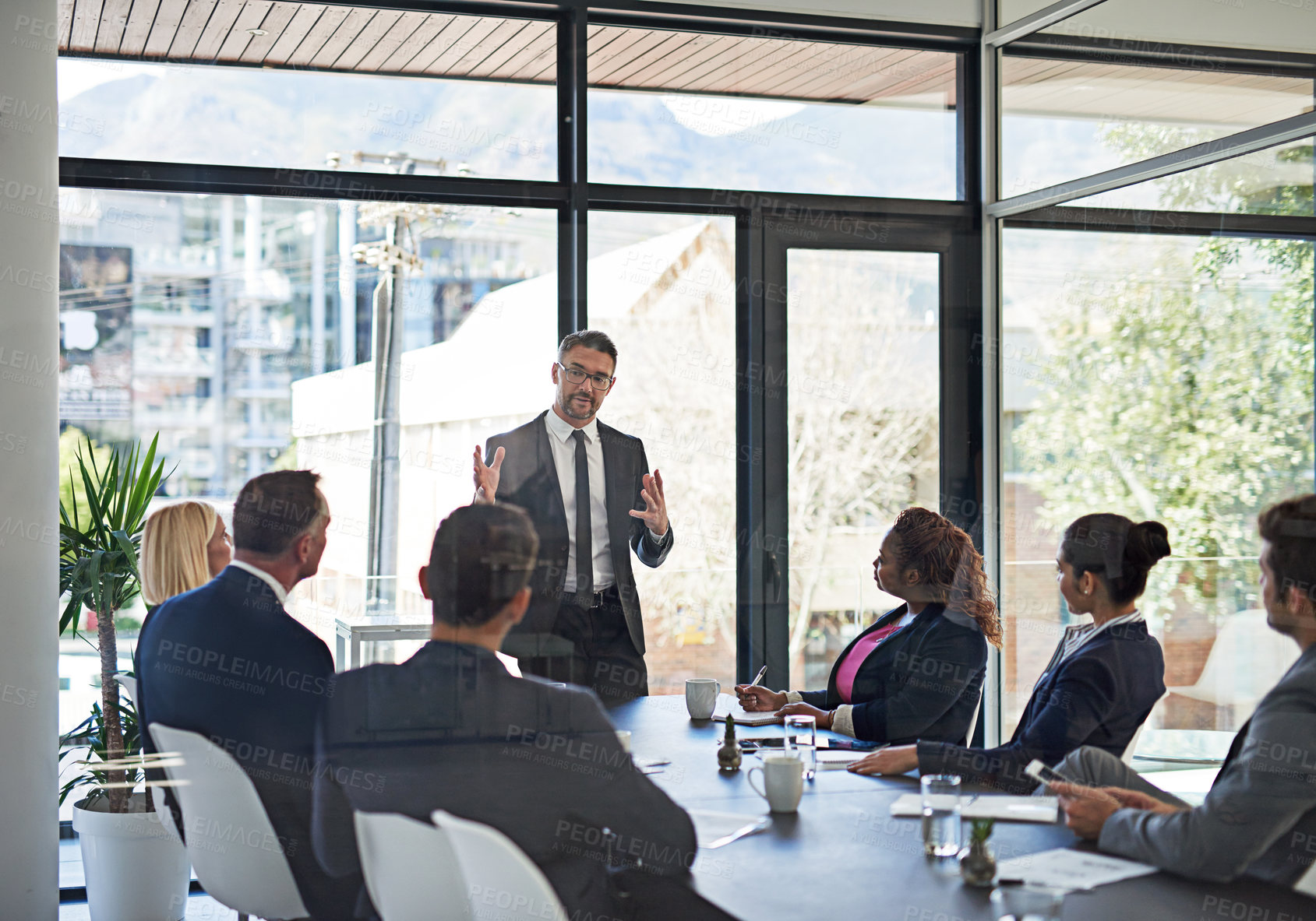Buy stock photo Shot of an executive giving a presentation to colleagues in a boardroom