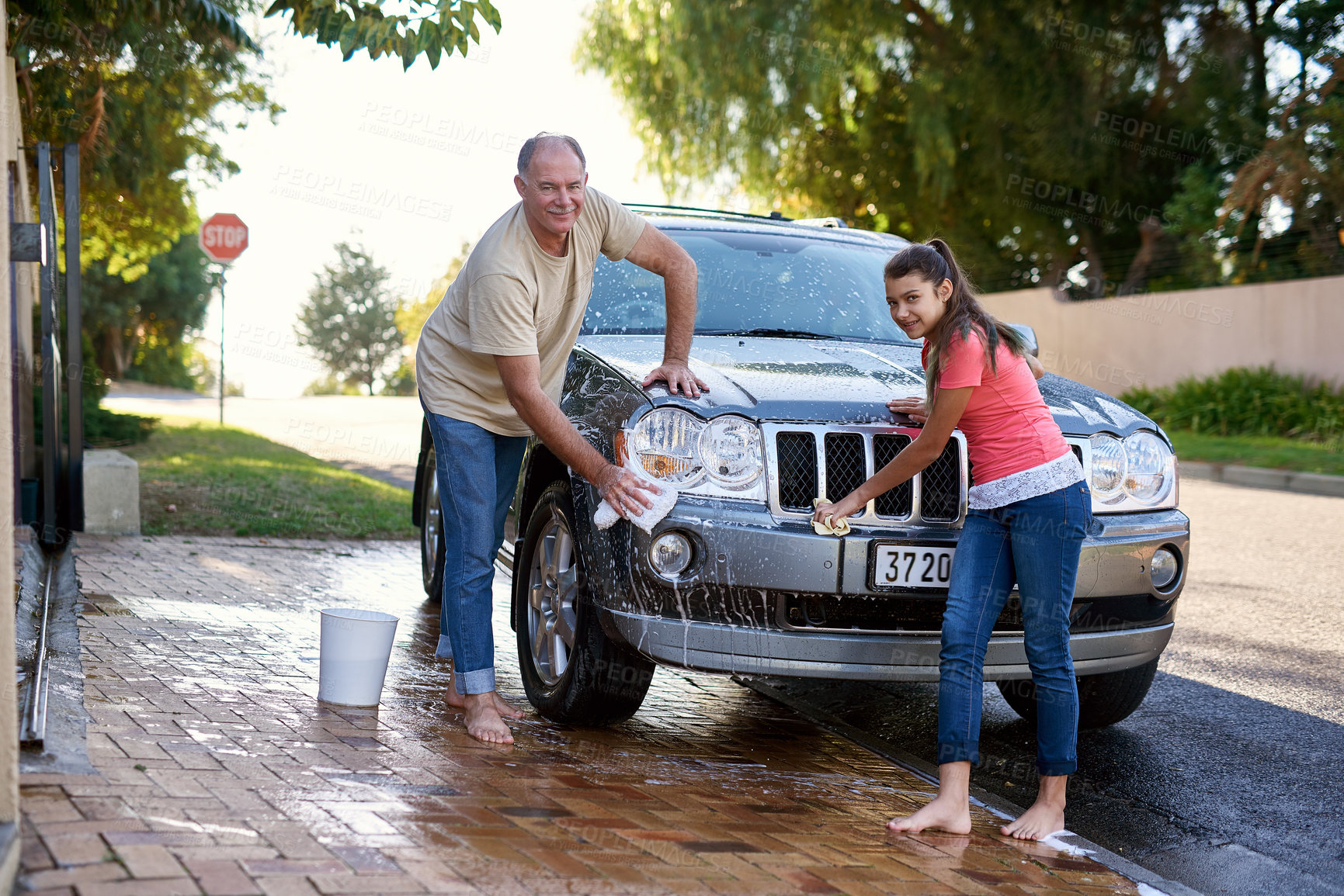 Buy stock photo Portrait, family and washing car with water, cloth and weekend chores on driveway. Cleaning transport, outdoor and father with smiling young daughter with soap, together and happy for helping routine