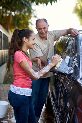 Buy stock photo Shot of a father and daughter washing a car together outside