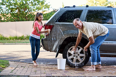 Buy stock photo Portrait, family and washing car with soap, cloth and quality time on driveway. Cleaning transport, outdoor and face of father with young daughter with water, barefoot together and weekend chores