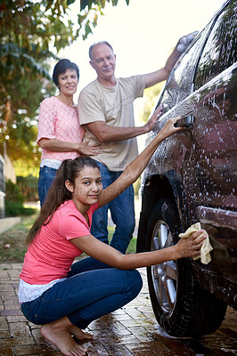 Buy stock photo Portrait of a family washing a car together outside