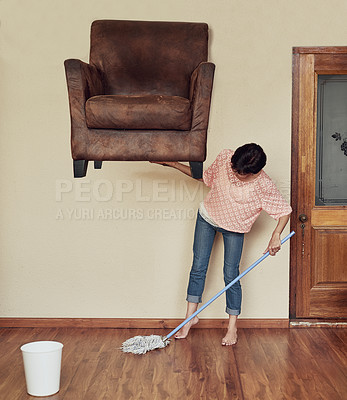 Buy stock photo Shot of a woman lifting a couch to mop underneath it
