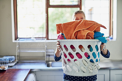 Buy stock photo Shot of a woman holding a basket of laundry