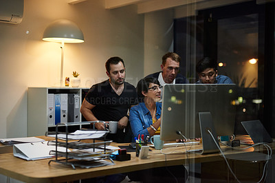 Buy stock photo Shot of employees working in an office at night