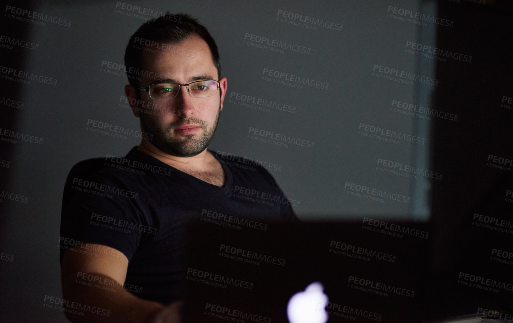 Buy stock photo Cropped shot of a young man working late in his office