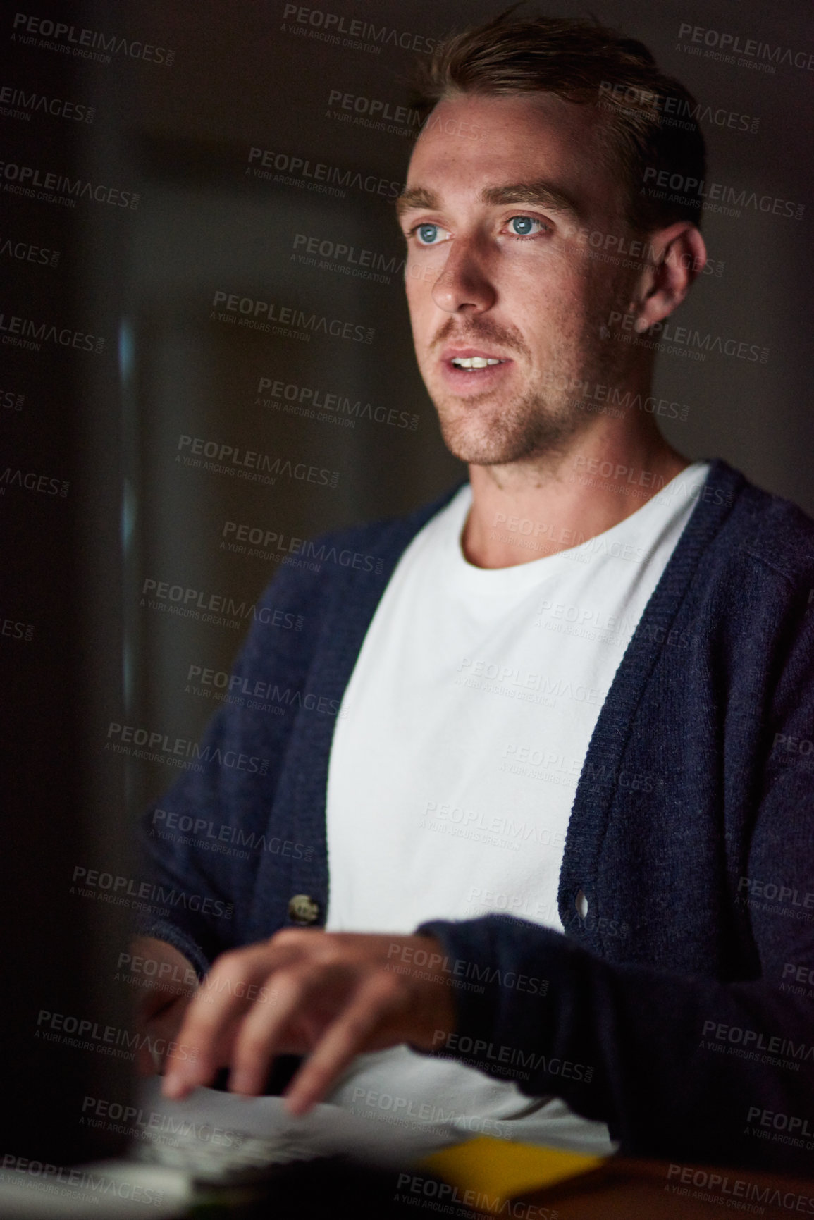 Buy stock photo Cropped shot of a young man working late in his office