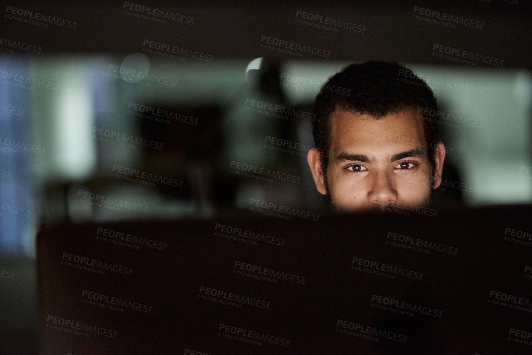 Buy stock photo Cropped shot of a young man working late in his office