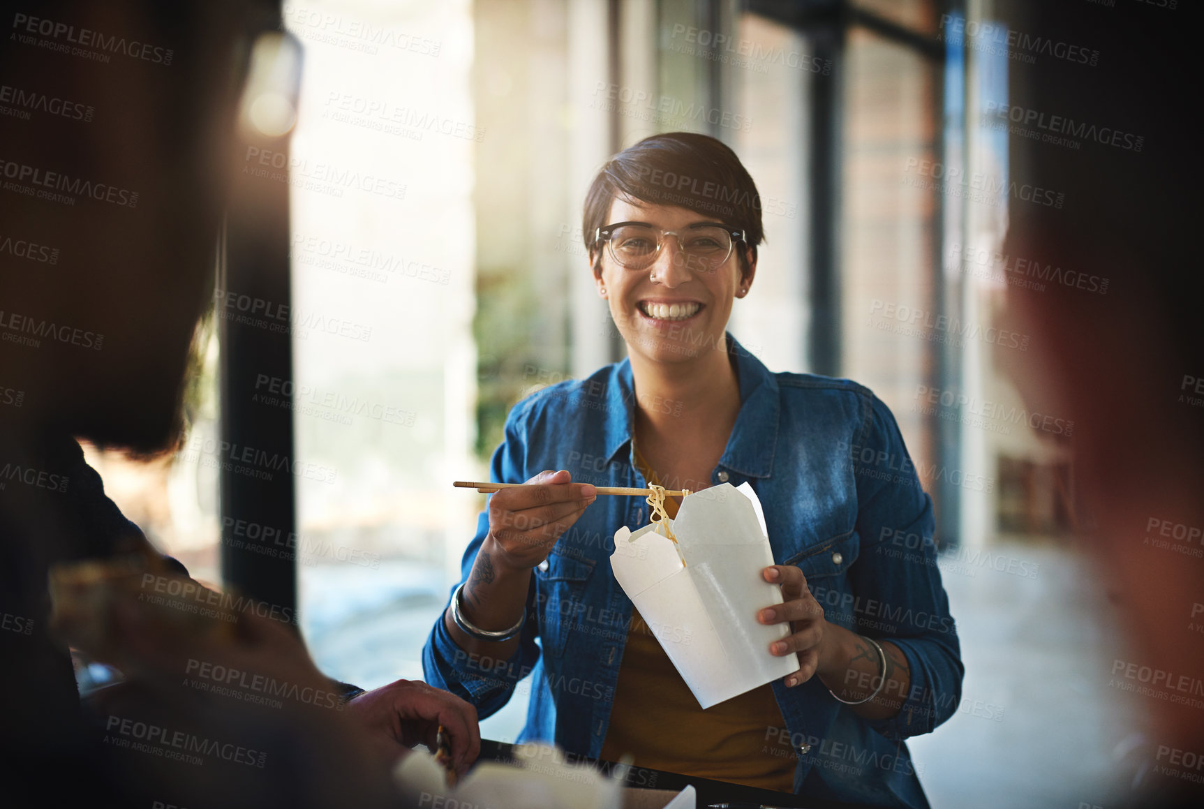 Buy stock photo Creative, business and happy woman in meeting with fast food, smile and planning for collaboration together. Eating, lunch and design team in workshop for development, growth and startup office