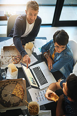 Buy stock photo Shot of a group of colleagues eating while having a meeting in the boardroom