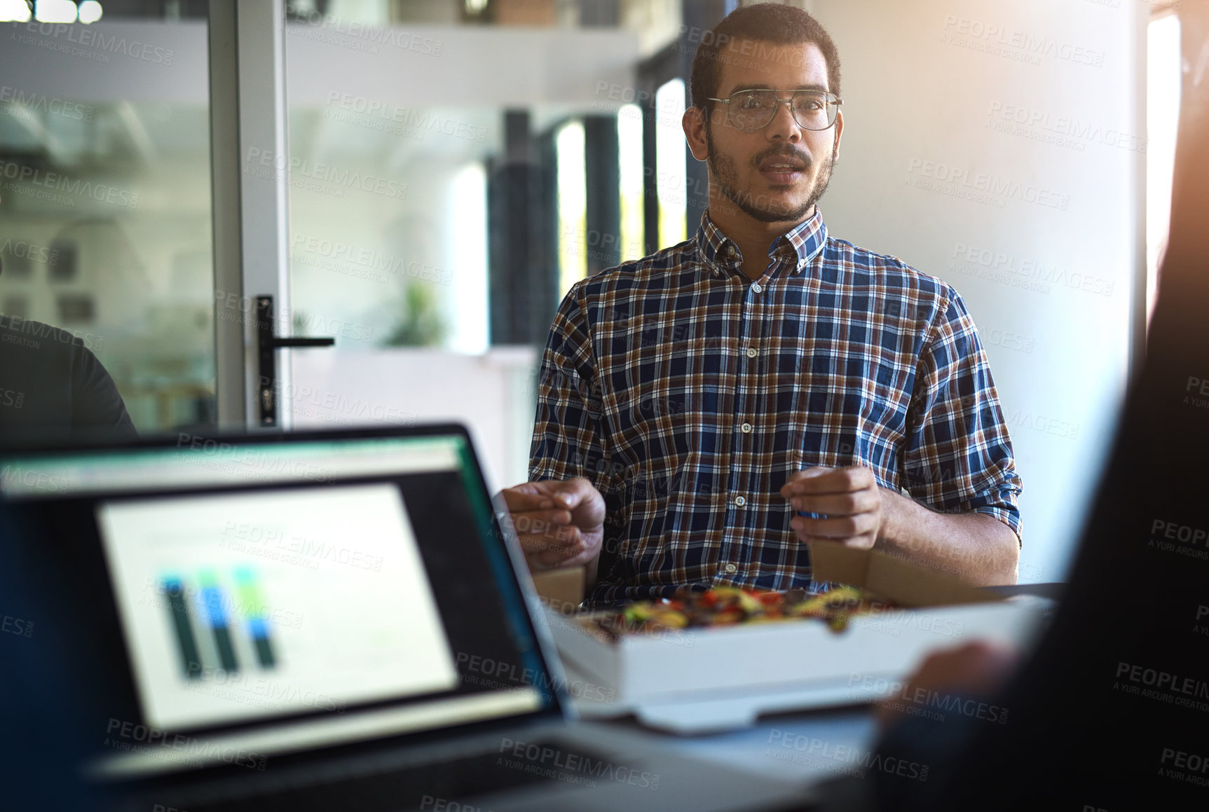 Buy stock photo Shot of a group of colleagues eating while having a meeting in the boardroom