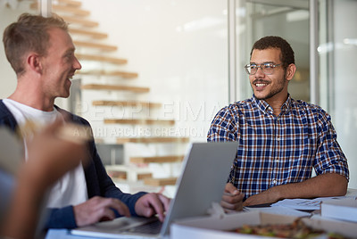 Buy stock photo Shot of a group of colleagues eating while having a meeting in the boardroom