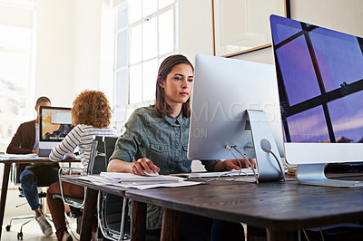 Buy stock photo Shot of colleagues working on their computers in an open plan office