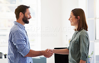 Buy stock photo Shot of coworkers shaking hands in a modern office