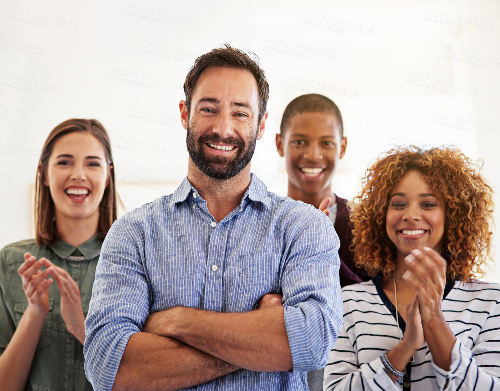 Buy stock photo Portrait of a team of colleagues standing in an office and clapping