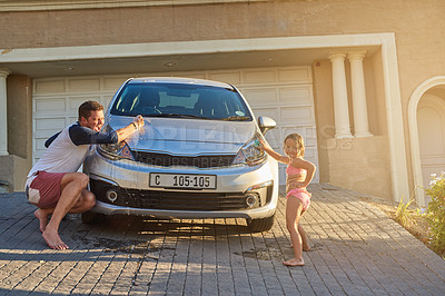 Buy stock photo Father washing car with kid by home for learning, bonding and child development or growth. Love, family and dad teaching girl to clean vehicle with cloth for fun outdoor in driveway at house.