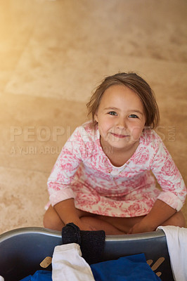 Buy stock photo Smile, basket and kid with laundry in home for learning to clean with development and growth. Happy, kitchen and portrait of girl child with clothes for washing with housekeeping at apartment.