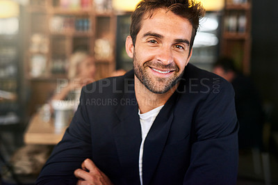 Buy stock photo Portrait of a handsome young man sitting in a cafe