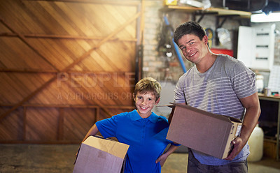 Buy stock photo Portrait of a father and son carrying boxes together