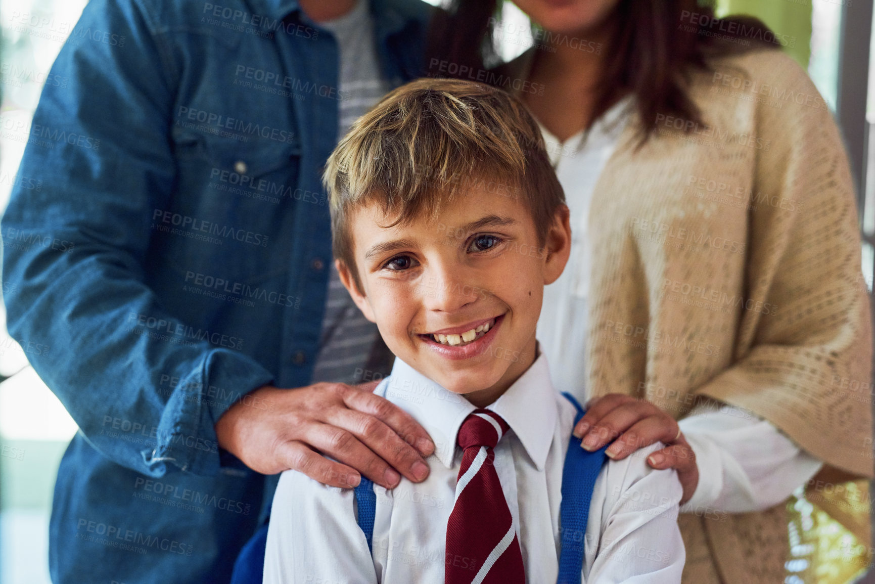 Buy stock photo Shot of a young schoolboy standing with his parents