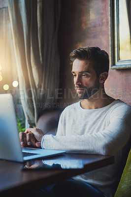 Buy stock photo Cropped shot of a young man using his laptop in a coffee shop