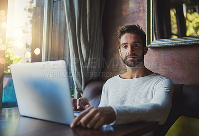 Buy stock photo Cropped portrait of a young man using his laptop in a coffee shop