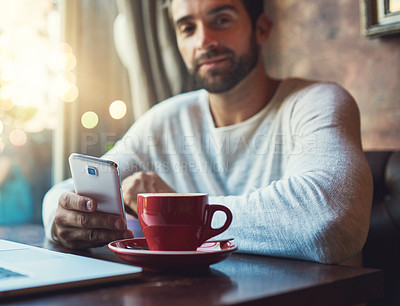 Buy stock photo Cropped portrait of a young man using his cellphone in a coffee shop