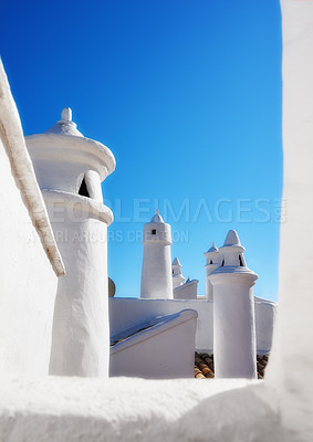 Buy stock photo Historic ventilation chimney on a roof of a vintage building. Traditional architecture airing system in a village. Exterior view of a rural home or house rooftop isolated on a blue sky background