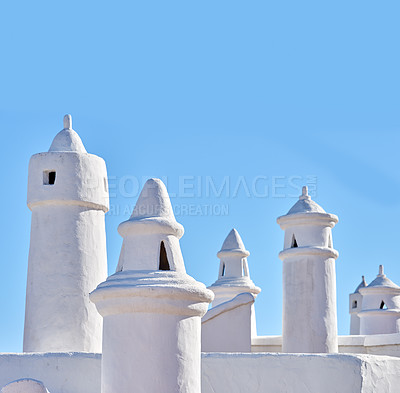 Buy stock photo Traditional ventilation chimney on a roof isolated on blue sky background. Exterior of historical or ancient air tubes on rural white stone house or primitive building. Simple minimalist architecture