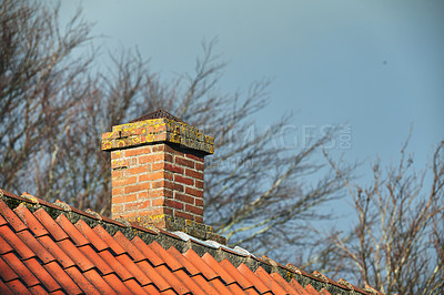Buy stock photo Red brick chimney designed on asbestos slate roof of house building outside with a sky background. Exterior construction architecture of escape chute built on rooftop for fireplace smoke and heat
