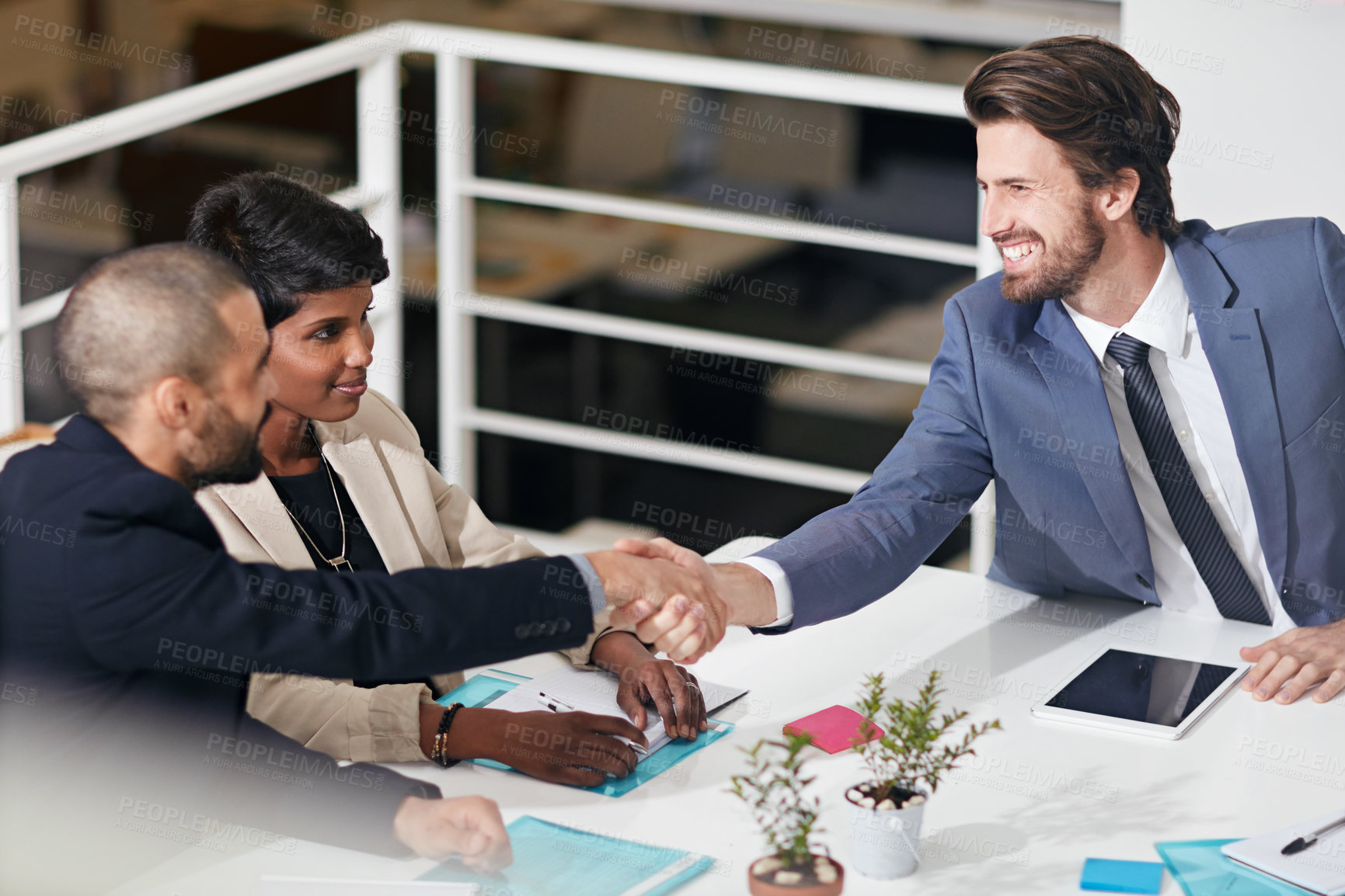 Buy stock photo Shot of businesspeople shaking hands in an office meeting
