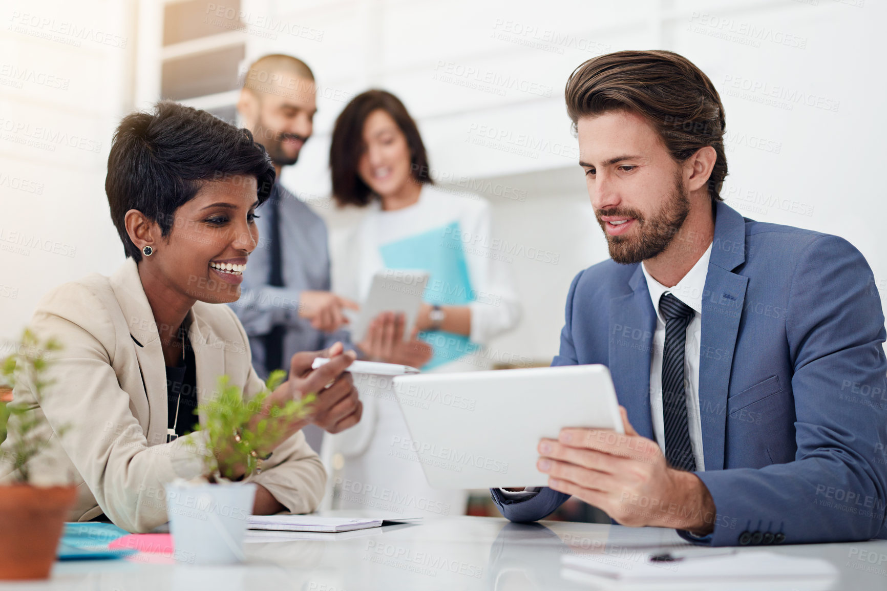 Buy stock photo Shot of businesspeople using digital tablets in an office meeting