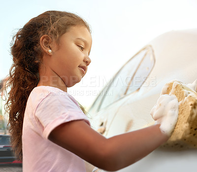 Buy stock photo Shot of a young girl washing a car outside