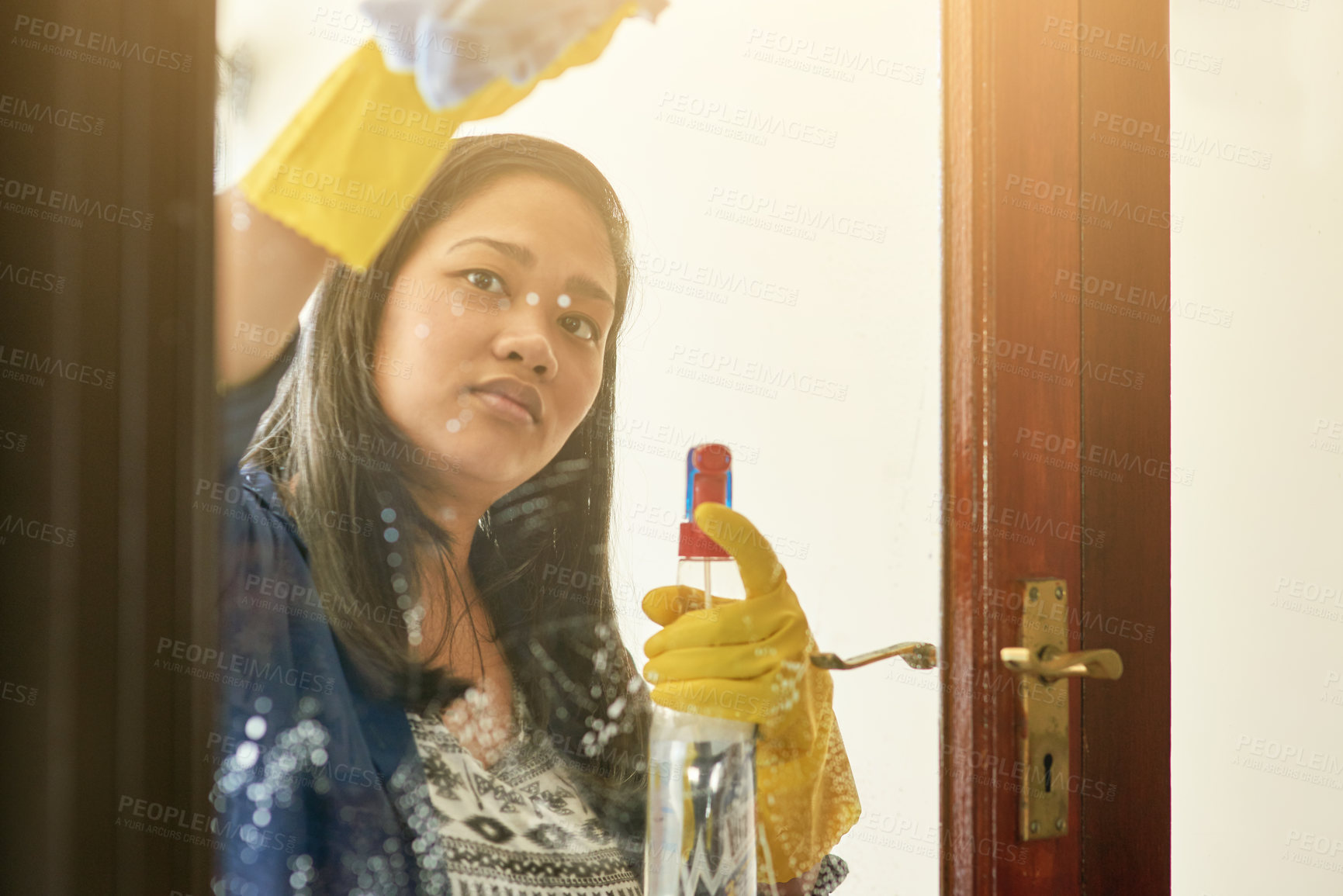 Buy stock photo Woman, glass and cleaning door with spray in home for housekeeping chores, window or product. Female person, cloth and gloves or washing dirt as professional service for hygiene, germs or liquid soap