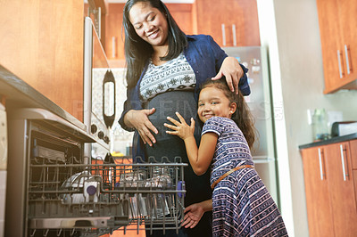 Buy stock photo Pregnant mom, young girl and hug in kitchen for happiness, love and dishwasher in family home. Mother, daughter and portrait in apartment for learning, cleaning and helping for child development