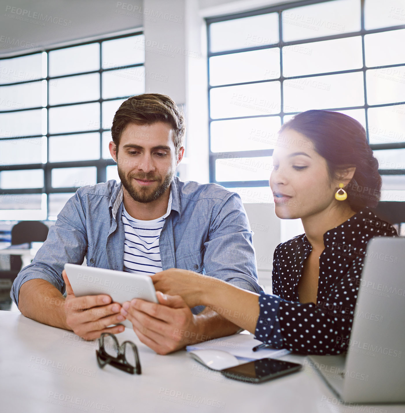 Buy stock photo Collaboration, tablet and opinion, man and woman in office sharing idea at meeting for creative project. Teamwork, planning proposal and happy employees in discussion at tech startup or design agency