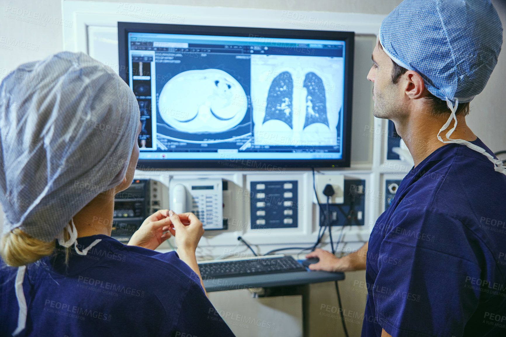 Buy stock photo Shot of a team of surgeons discussing a patient’s medical scans