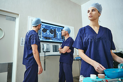 Buy stock photo Shot of a team of surgeons preparing for surgery