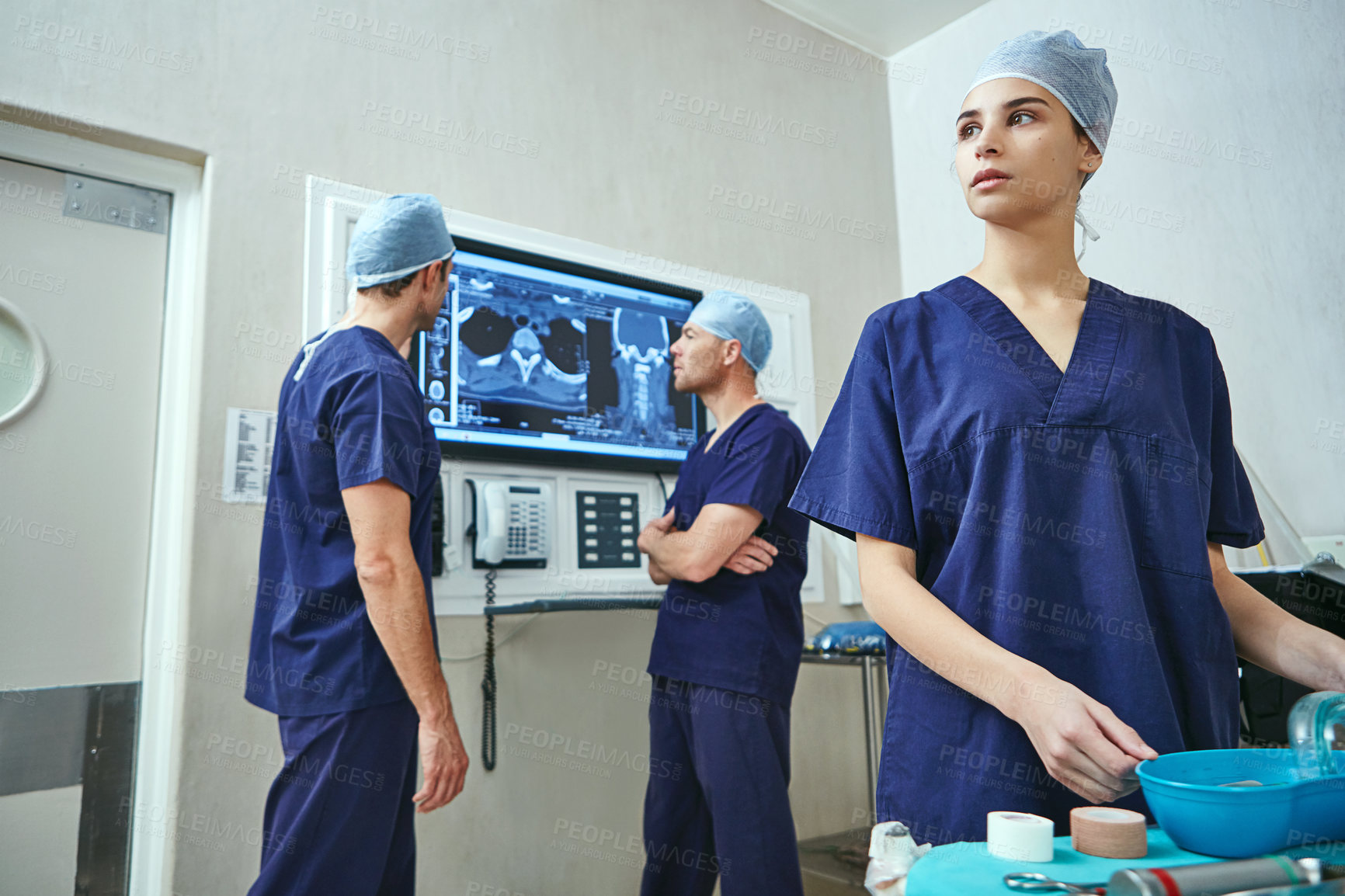 Buy stock photo Shot of a team of surgeons preparing for surgery